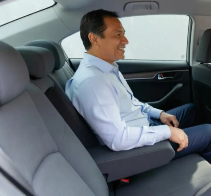Happy customer enjoying a comfortable taxi ride